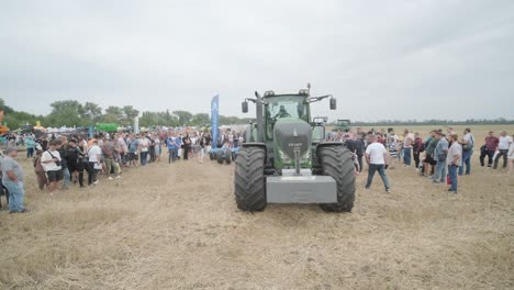 demonstration of agricultural machinery at an exhibition. tractors operate in the field, showcasing their capabilities and performance in action