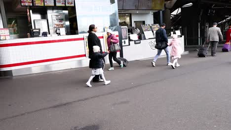 pedestrians walking on a bustling melbourne street