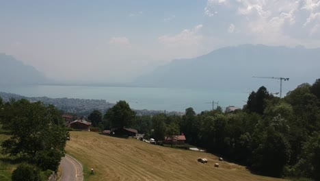 Sweeping-aerial-shot-of-Lac-Léman---Lake-Geneva,-with-The-Alps-in-the-background