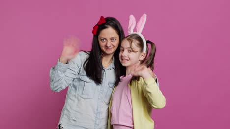 Lovely-schoolgirl-with-bunny-ears-an-her-mom-waving-on-camera