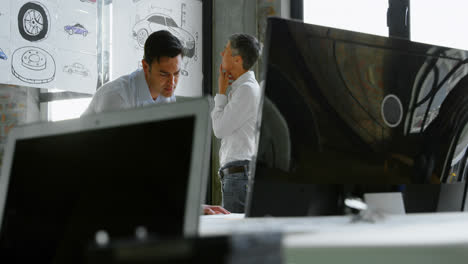 car designers working at desk 4k