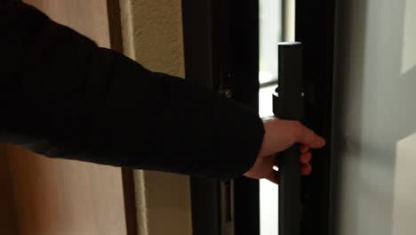 person opening a modern door