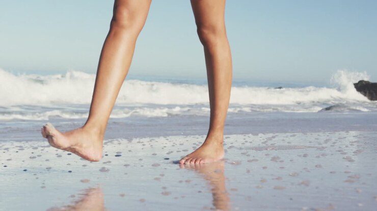African American woman walking seaside