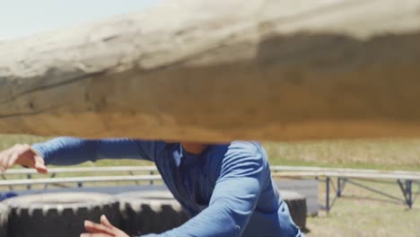 fit african american man climbing under and over hurdles on obstacle course in the sun