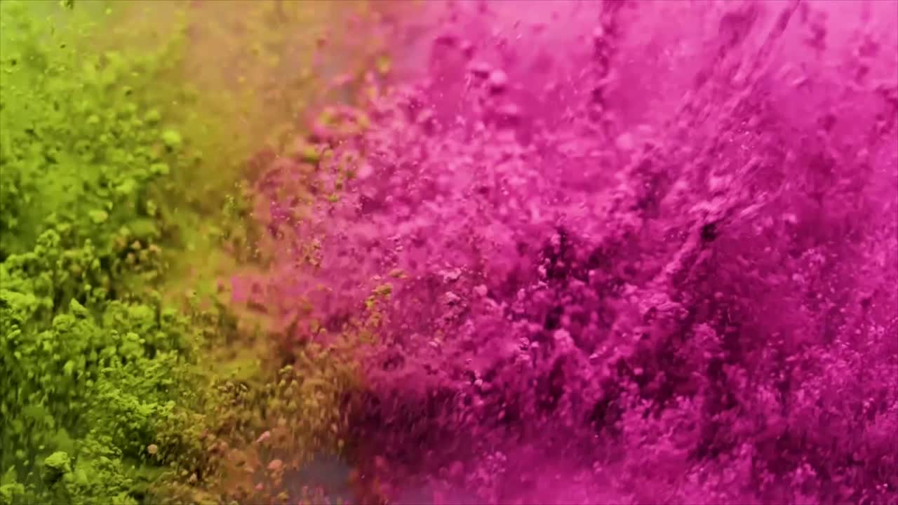 Polvo vibrante verde y rosa explotando en cámara lenta