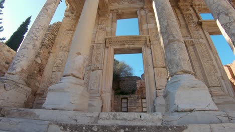 downward panning capturing ancient traces and details of tall columns at celsus library ephesus