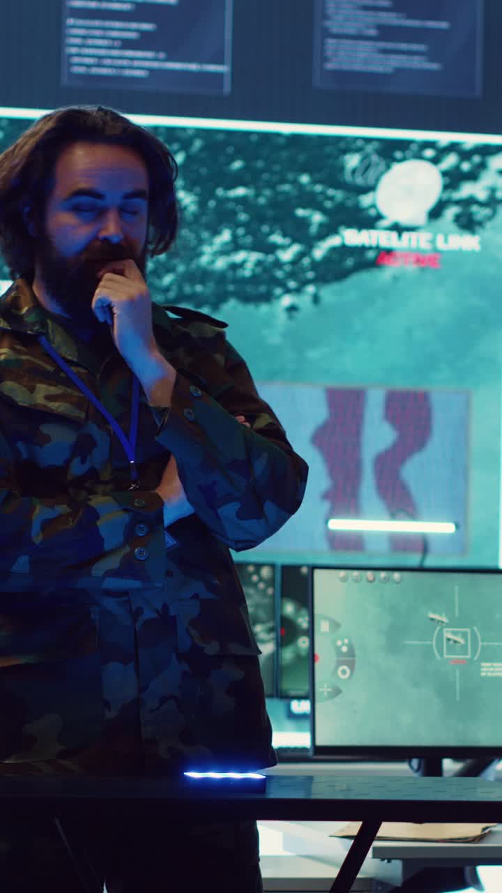 Military Man Monitoring Satellite Link in High-Tech Control Room