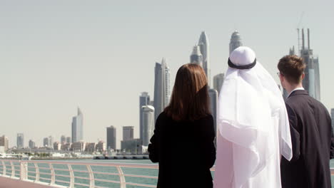 three people looking at the city