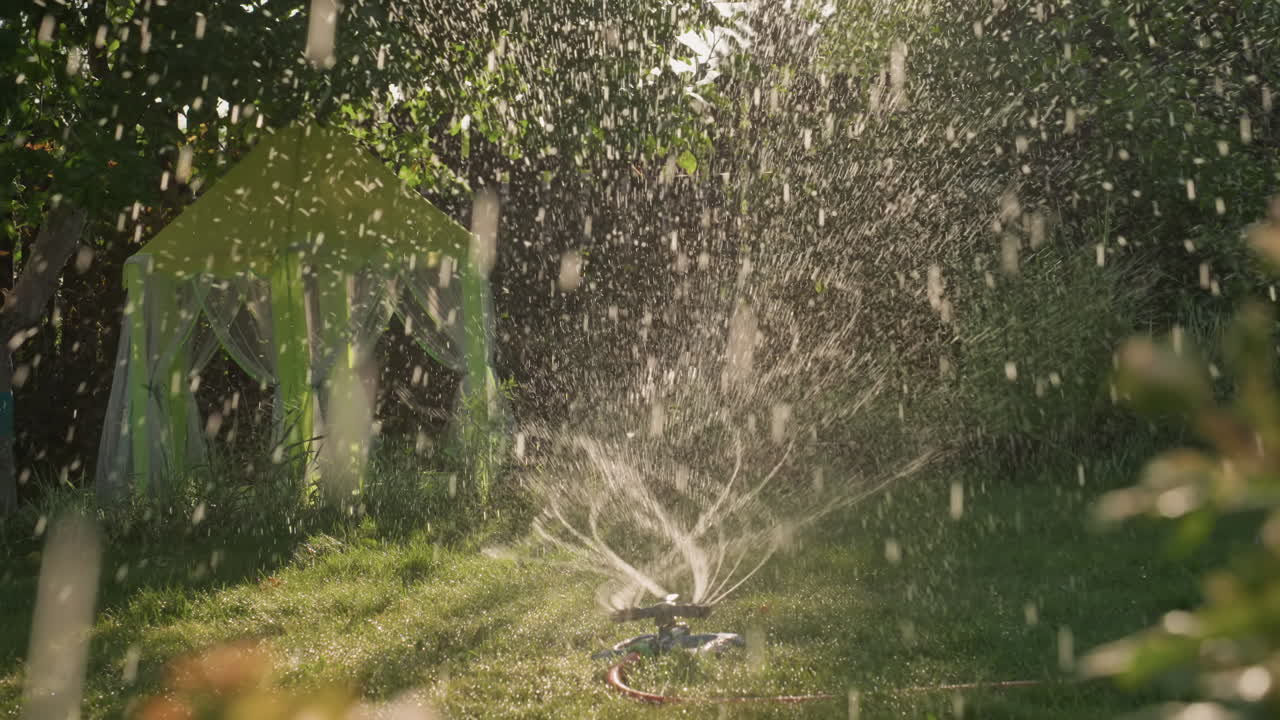 Sunny Water Burst, Bright Midday Water Spray Revitalizes Expansive Grassy Area Beautifully, Exciting Garden Mist Sprays Sparkle Over Flourishing Green Lawns In Bright Afternoon Sunlight