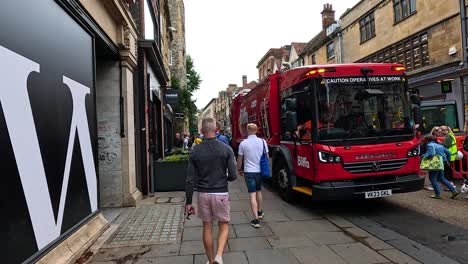 pedestrians navigate around a garbage truck