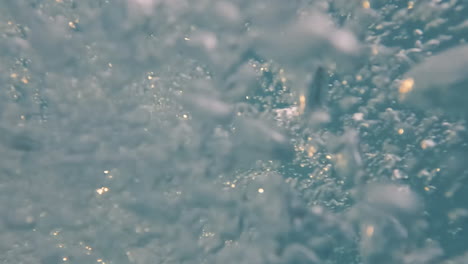 cinematic slow motion shot of bubbles underwater creating interesting shapes, 4k, 120fps, slomo