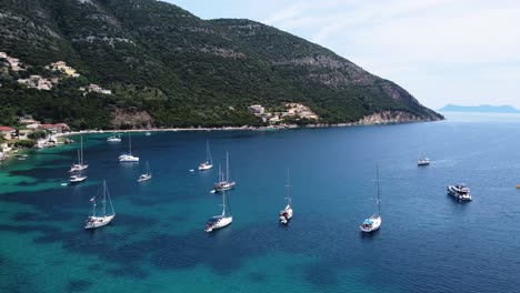 Orbital-over-Mikros-Poros-Gialos-Beach-Bay,-Sailing-Boats,-Lefkada,-Greece