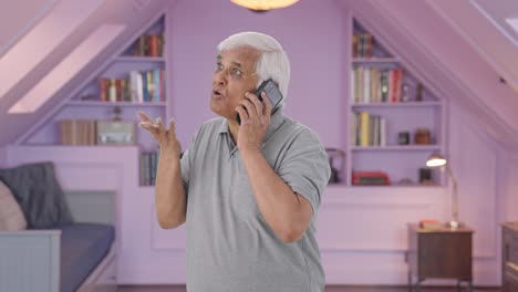 angry indian old man shouting on call