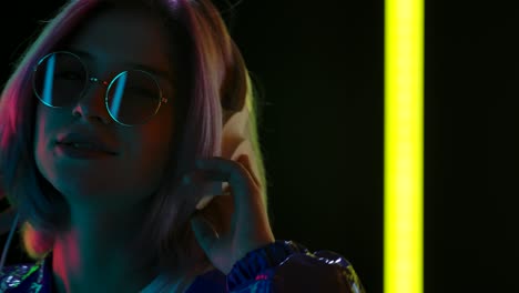 woman listening to music with headphones and neon lights