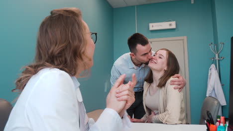 vista trasera del ginecólogo hablando con su paciente en la consulta médica