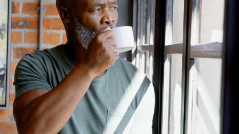 senior man having coffee in living room 4k