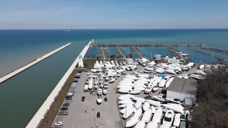 boats storage area, outside nautical parking dock for sailing yachts and leisure boats at port dalhousie pier ontario canada, off season empty harbor marina and coastal landscape, aerial view