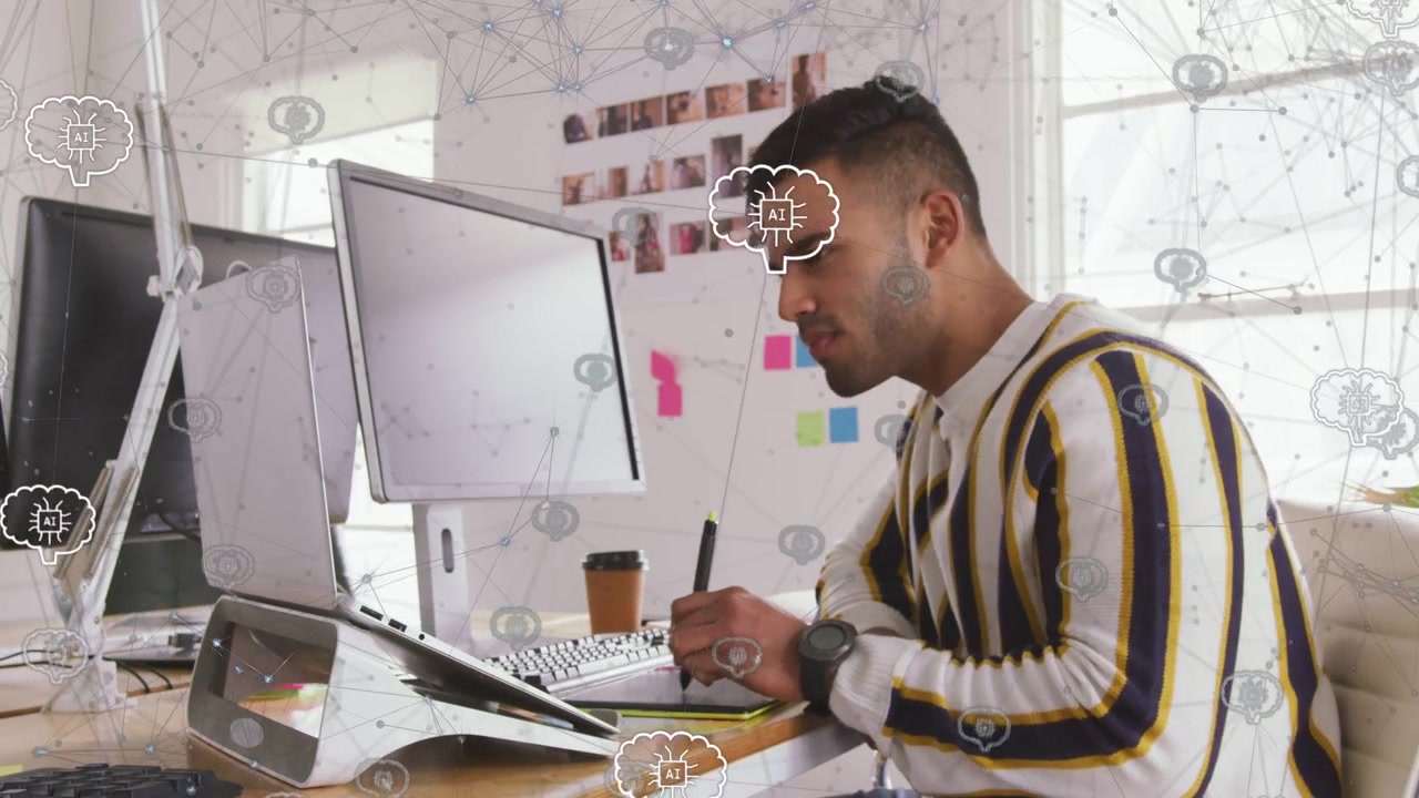 Male designer glancing monitor then noting on tablet, network icons guiding stylus to finish design