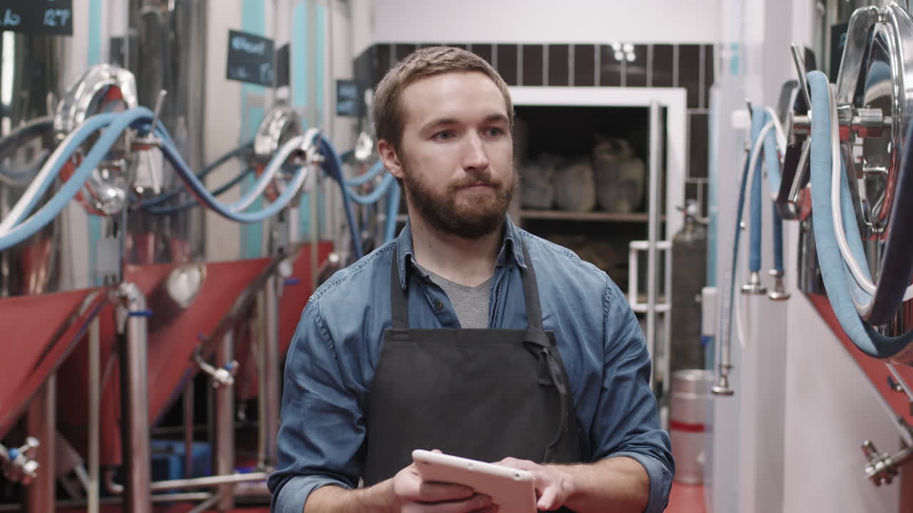 Brewery Worker With Digital Tablet At Factory