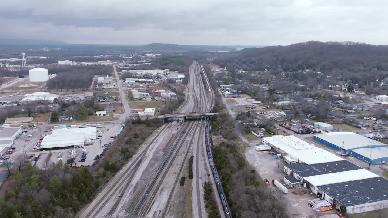 Aerial footage flying over the railroad tracks of east Chattanooga with a train coming into the railyard.