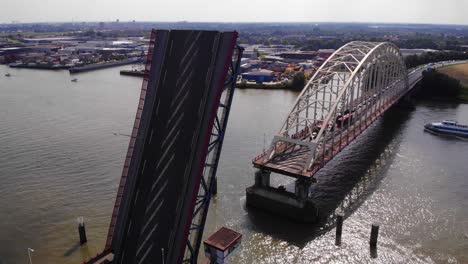 opened lifting bridge on noord river with ship crossing at sunny day in alblasserdam, south holland, netherlands - static