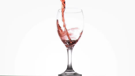 red wine being poured in super slow motion in a glass