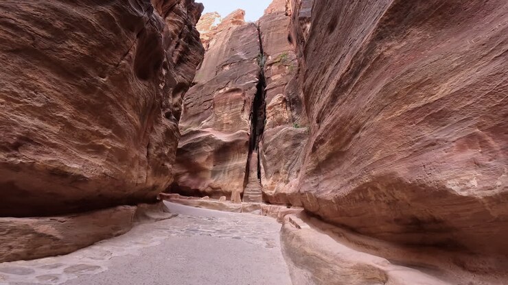 View on the ancient road paved with the stones. Low angle view on the canyon rocks in Jordan, West Asia.
