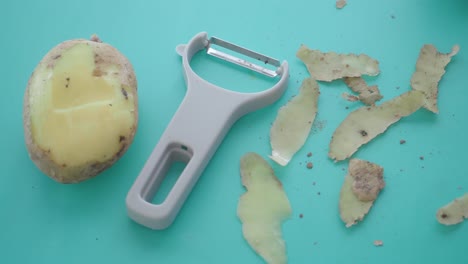 peeling a potato with a vegetable peeler