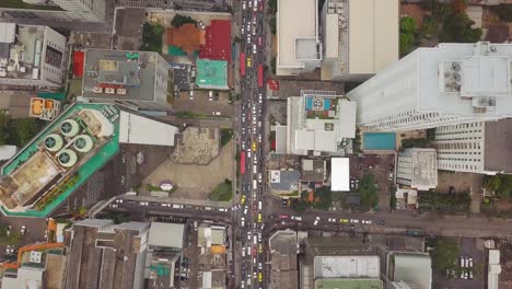 aerial shot of the city with tightly packed roads and stagnant traffic with tall building around