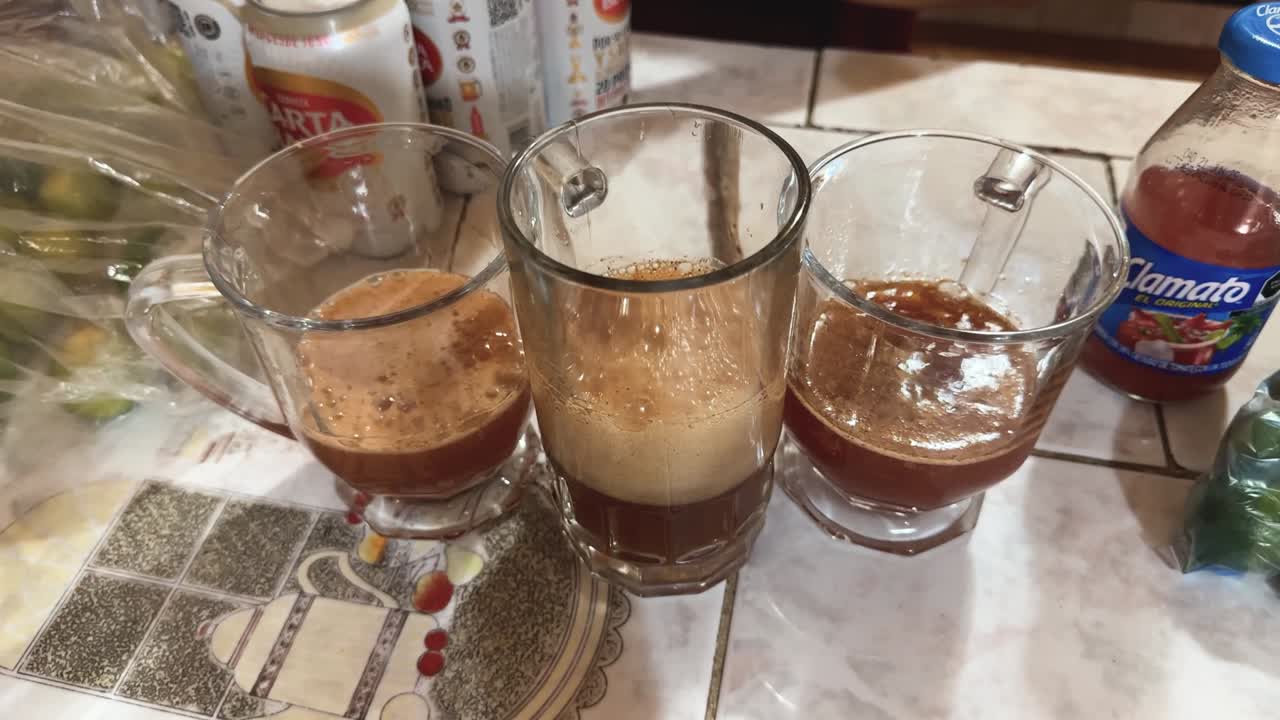 Preparing micheladas by filling jars with beer and a sauce-lime mixture