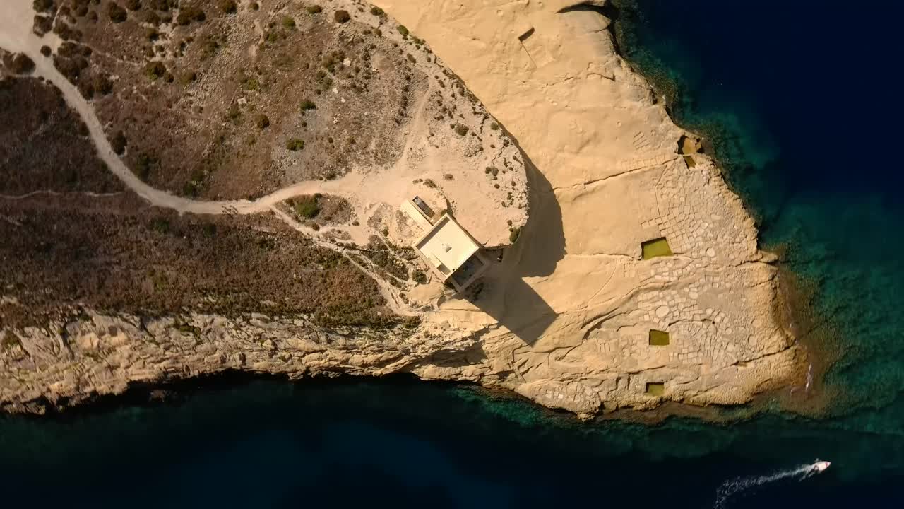 Drone spiral towards Xlendi's Tower in Gozo