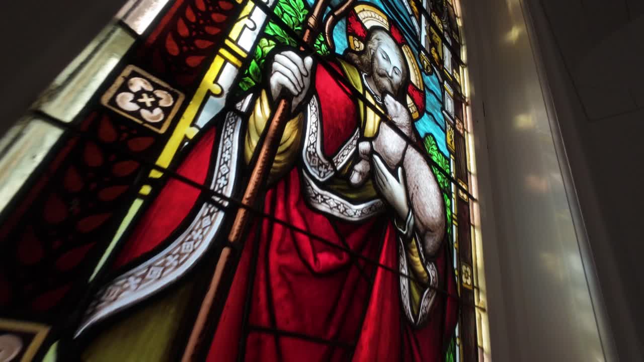 Intricate details of religious stained glass windows inside a church in Quebec City, Canada
