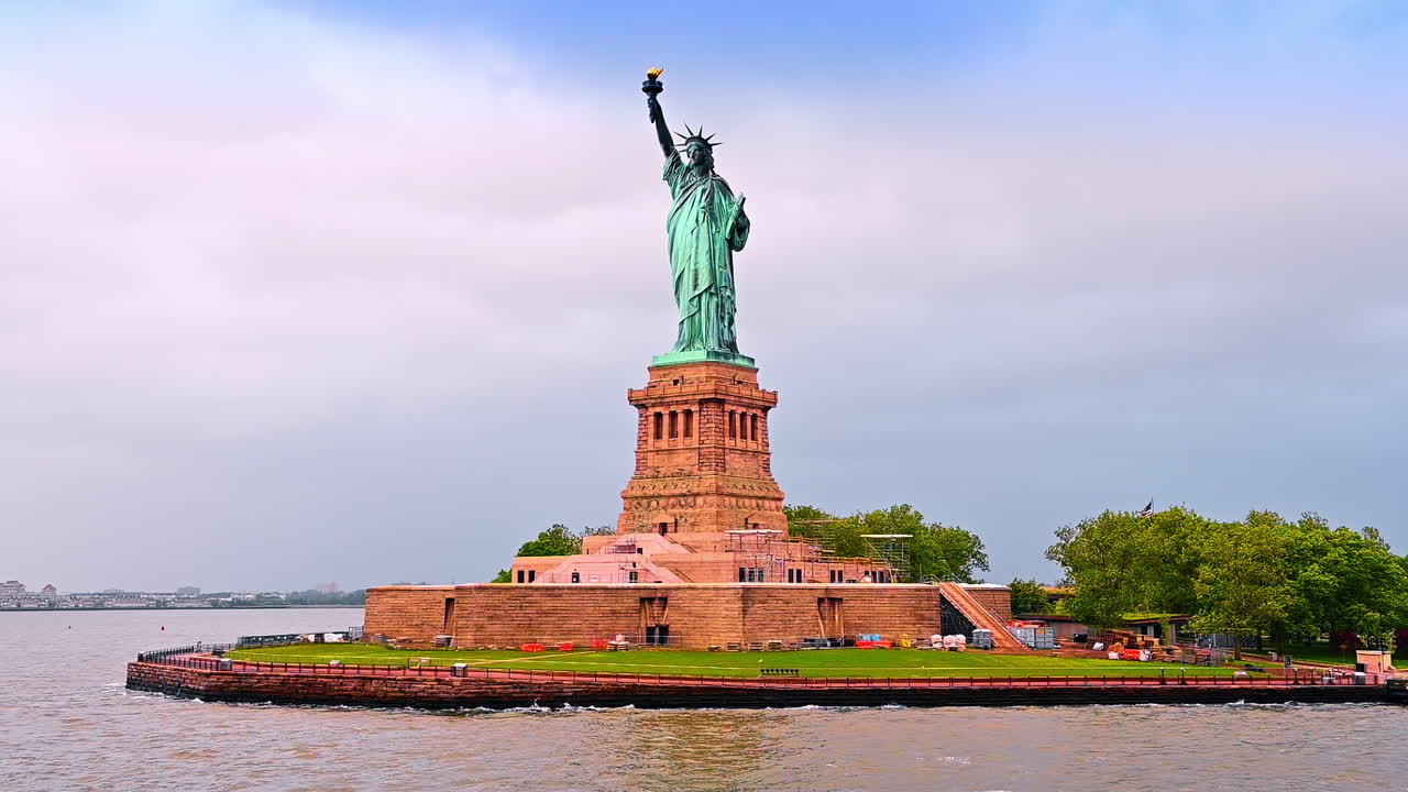 Statue of Liberty from low angle perspective. Some building materials at the foot of the monument. New York, USA