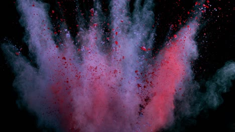 super slow motion of colored powder explosion isolated on dark background.