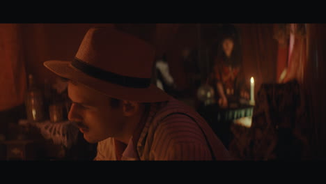a man in hat checks the inside of the gypsy circus cart