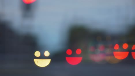 colorful smiley face emoji bokeh from moving car and traffic lights at the evening, social media emoji background concept