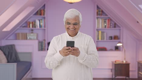 Happy-Indian-old-man-chatting-on-phone