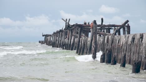 Small-sea-waves-splashing-on-old-bridge-remains