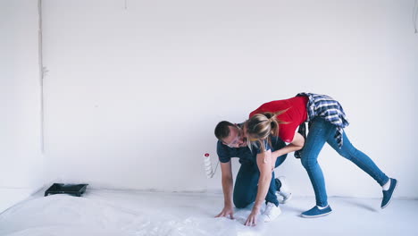 couple-with-foil-and-roller-hugs-at-construction-in-room