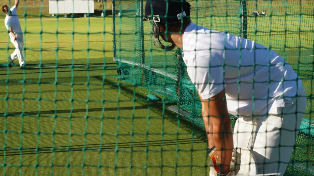 Cricket players practicing in the nets during a practice session