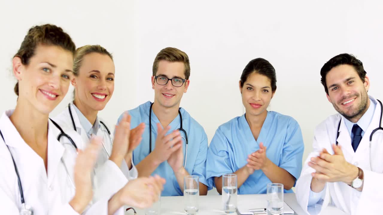 Medical team applauding at the camera
