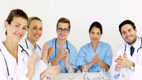 medical team applauding at the camera