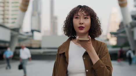 woman using smartphone in city