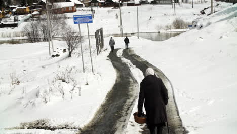 snowy village road with people
