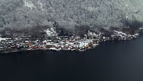 footage filmed with a drone over a lake by a town called hallstatt in austria in europe