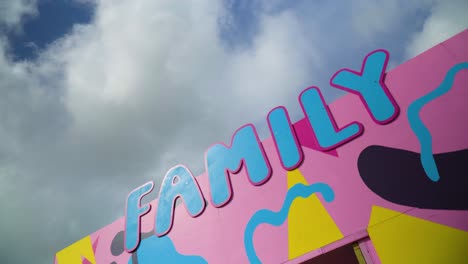 family sign in blue colour and pink outlines colourful background spinning 360 orbit camera movement creative childish kids area designated to play relax leave kids to be cared for nursery games