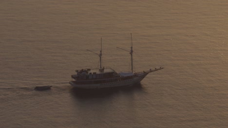 sailing ship navigating in open sea during twilight