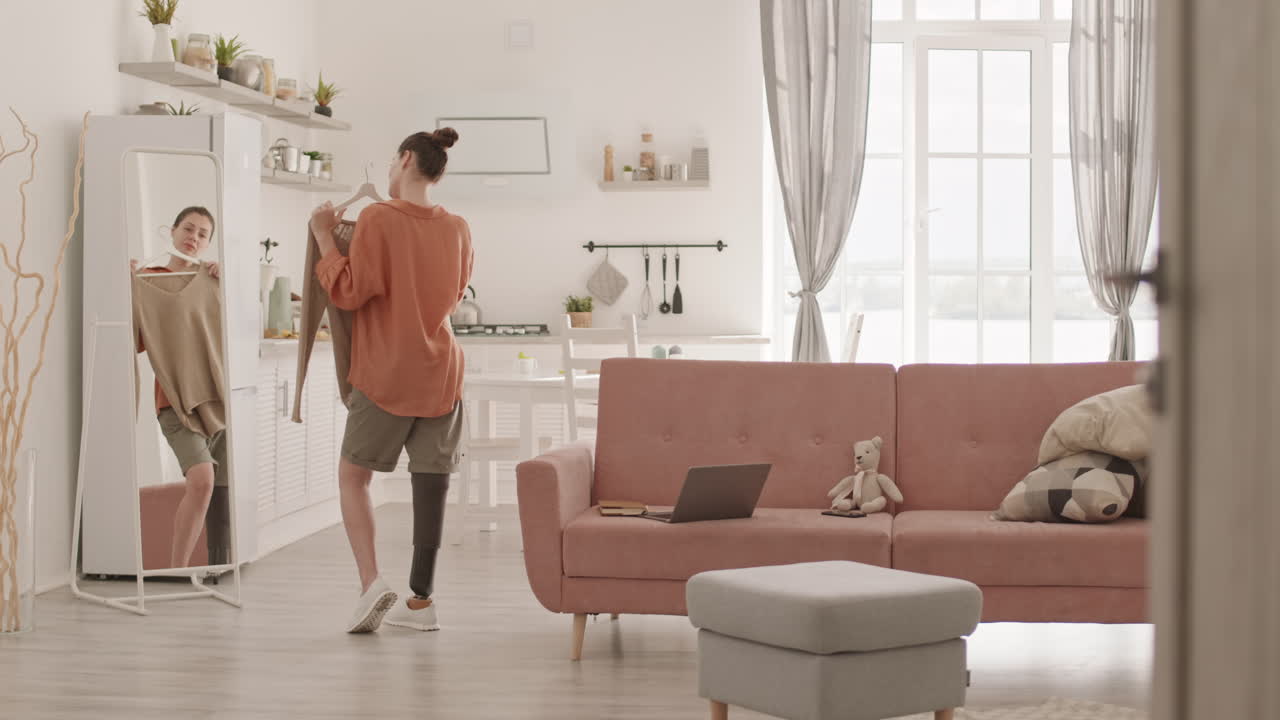 Woman Choosing Clothes in front of Mirror