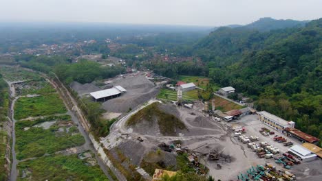 Machines-in-concrete-factory-in-topical-forest,-Muntilan,-Indonesia,-aerial-view