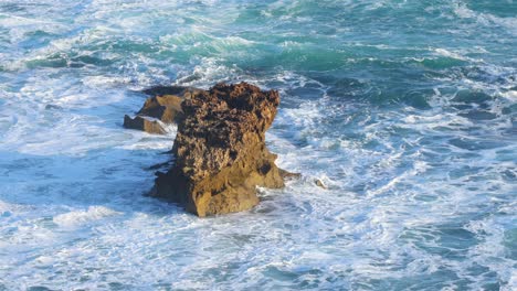 waves crashing against a rocky cliff